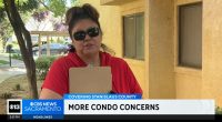 Woman in red shirt holding clipboard discusses condo concerns.