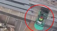 Video still of a forklift falling from a platform at a construction site.