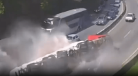Multi-vehicle accident on highway with large cloud of dust or smoke.