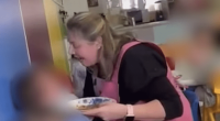 Screenshot of a woman appearing distressed while holding a plate of food in a nursery setting.