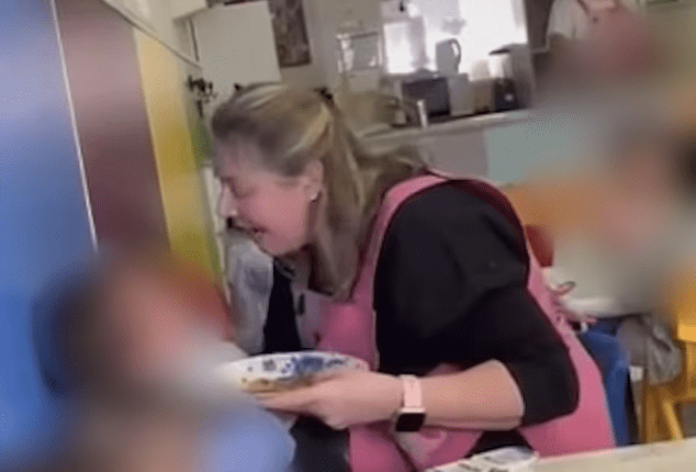 Screenshot of a woman appearing distressed while holding a plate of food in a nursery setting.