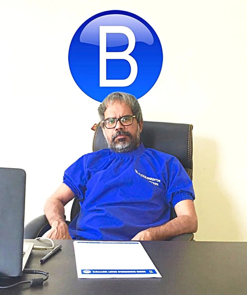 Dr. Narendra Vikramaditya Yadav sitting at his desk.