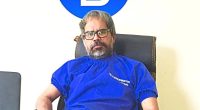 Dr. Narendra Vikramaditya Yadav sitting at his desk.