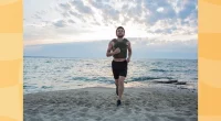 athlete training with a weighted vest on the beach