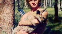 A man holding a kangaroo joey.