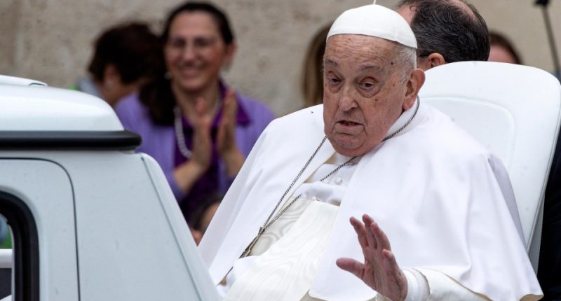 Pope Francis waving to the faithful.
