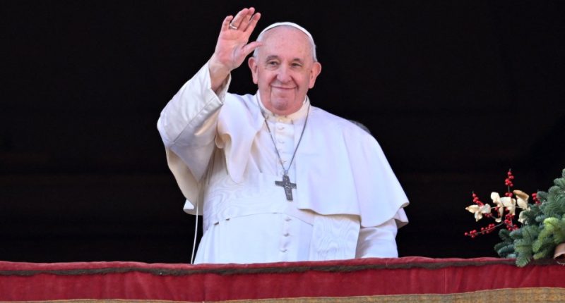 Pope Francis waving from a balcony.