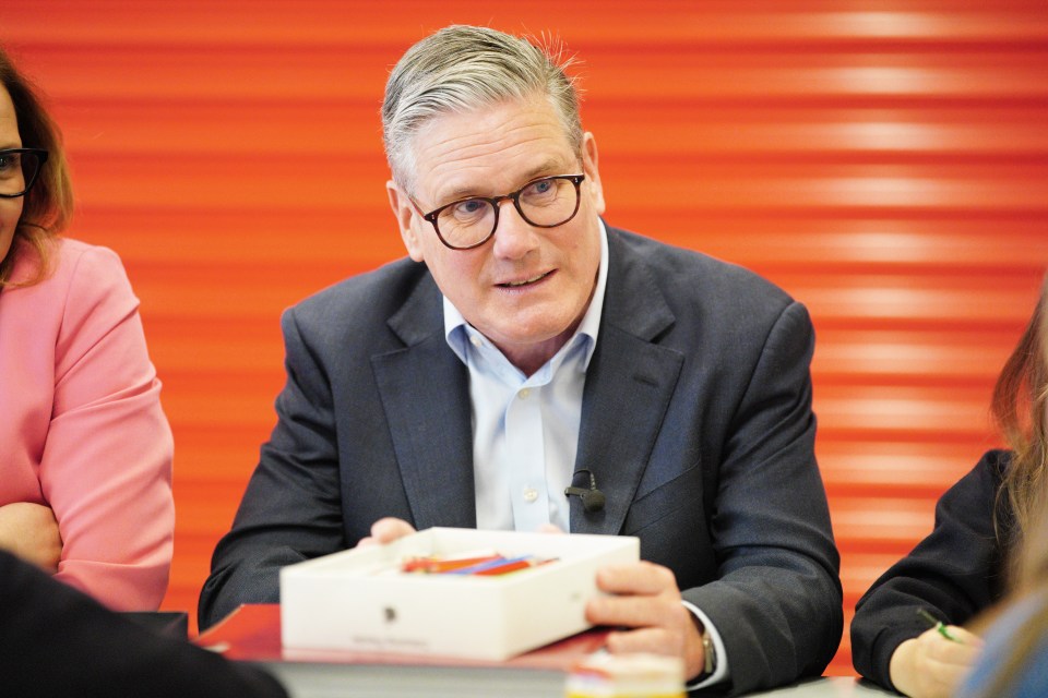 Prime Minister Keir Starmer speaking to children at a school.