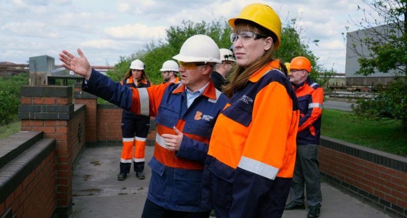 Government officials touring a British Steel plant.