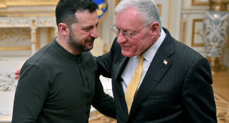 Two men in suits talking closely.
