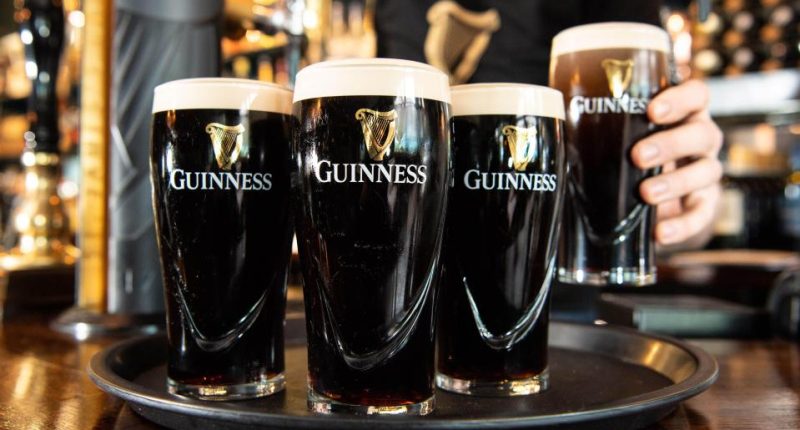 Four pints of Guinness on a tray.