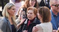 Family and supporters of Erik and Lyle Menendez outside a courthouse.
