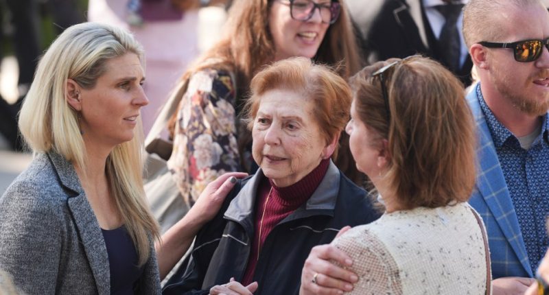 Family and supporters of Erik and Lyle Menendez outside a courthouse.