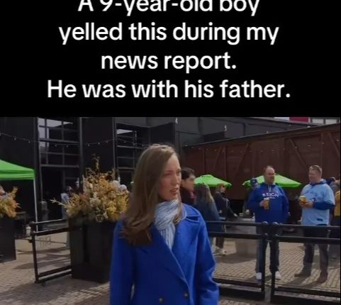 A news reporter in a blue coat during a report interrupted by a 9-year-old boy and his father.