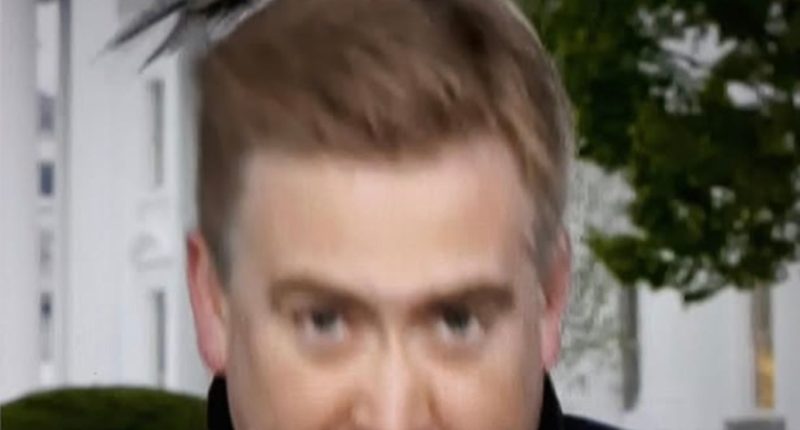 Screenshot of a man with a bird on his head.