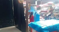Philippines market scene with food cart and table.
