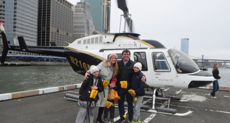 Family posing in front of a helicopter before a fatal crash.