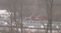 Sheriff's vehicle and solar panels in the snow.
