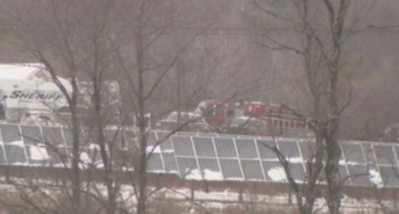 Sheriff's vehicle and solar panels in the snow.