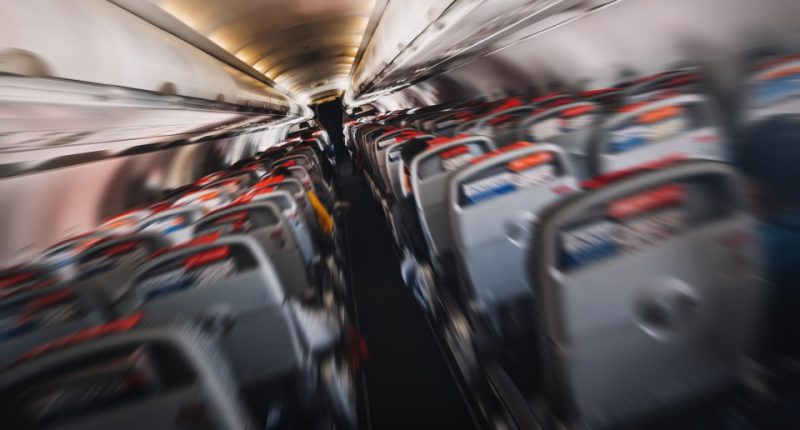 Blurred photo of airplane interior during turbulence.