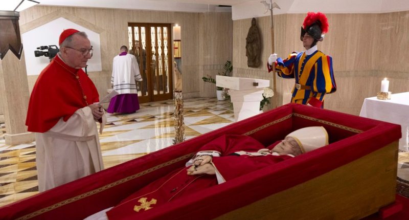 Cardinal Pietro Parolin praying before Pope Francis's body lying in state.