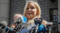 FILE - Virginia Roberts Giuffre holds a news conference outside a Manhattan court following the jailhouse death of Jeffrey Epstein, Aug. 27, 2019, in New York. A tentative settlement has been reached in a lawsuit accusing Prince Andrew of sexually abusing a 17-year-old American, according to a court filing Tuesday, Feb. 15, 2022. (AP Photo/Bebeto Matthews, File)