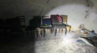 Alleged torture chamber in Kherson with chairs and debris on the floor.
