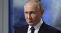Vladimir Putin in a dark suit and tie.
