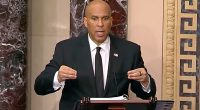 Senator Cory Booker speaking at a podium.