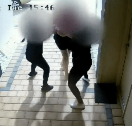 Security camera footage of a struggle between several people.