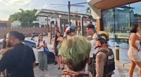 Police officers responding to a fight between British tourists and locals outside a convenience store in Thailand.