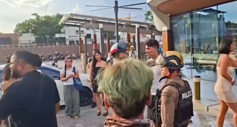 Police officers responding to a fight between British tourists and locals outside a convenience store in Thailand.