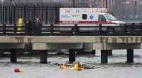 First responders stand on a pier at the scene where a helicopter crashed into the Hudson River, Thursday, April 10, 2025, in Jersey City, N.J. (AP Photo/Seth Wenig)