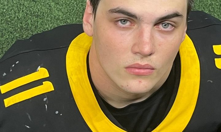 Portrait of Austin Metcalf in a football jersey.