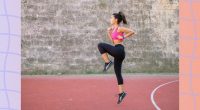 woman doing high knees exercise outdoors on track