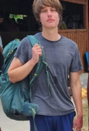 A young man with a backpack.