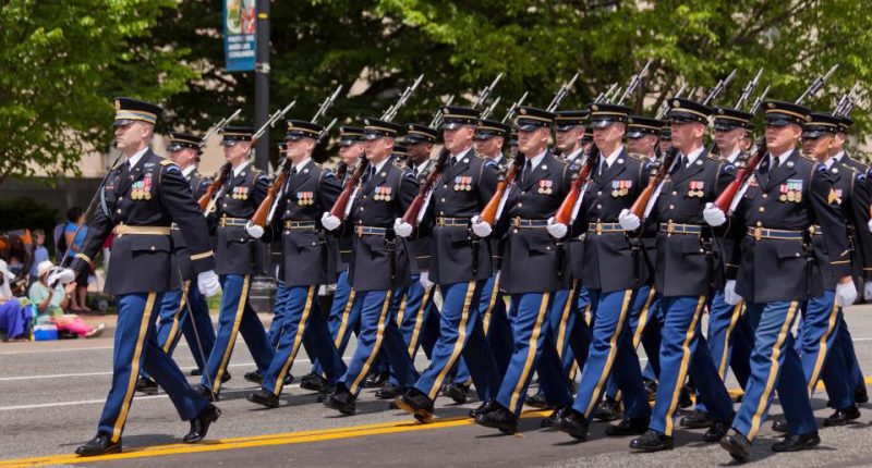 US Army honor guard marching in a parade.