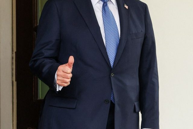 President Donald Trump giving a thumbs-up.