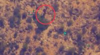 Aerial view of a desert landscape with a circled object.