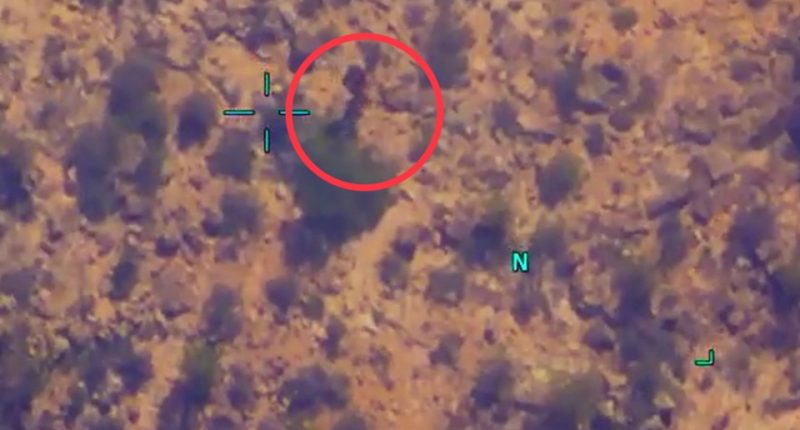 Aerial view of a desert landscape with a circled object.
