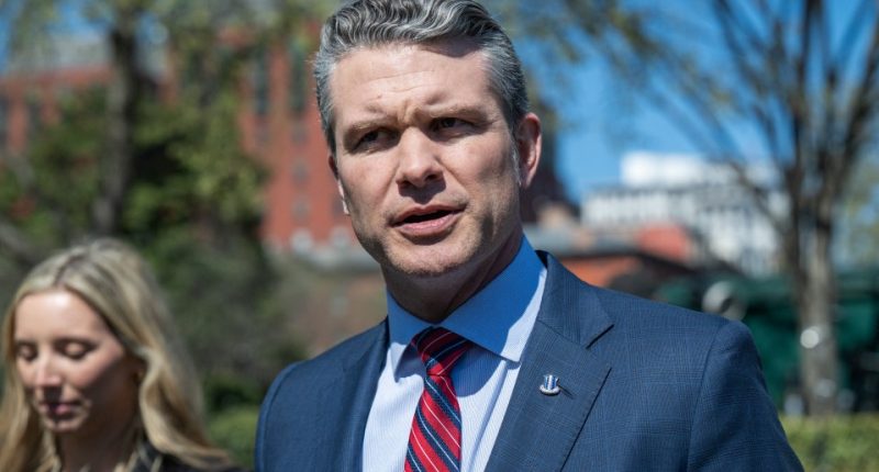 Headshot of a man in a suit speaking.