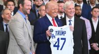 President Trump holding a Los Angeles Dodgers jersey with other people.