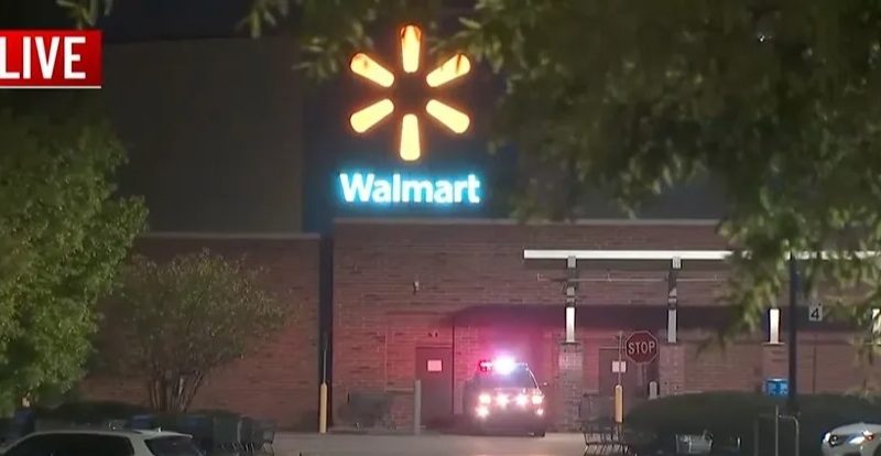 Police car outside a Walmart at night.