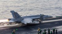US Navy F/A-18 Super Hornet launching from aircraft carrier.