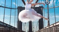 Ballet dancer leaping on a bridge.