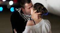 Ksenia Karelina kissing her fiancé, boxer Chris van Heerden.