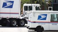 USPS trucks parked at a post office.