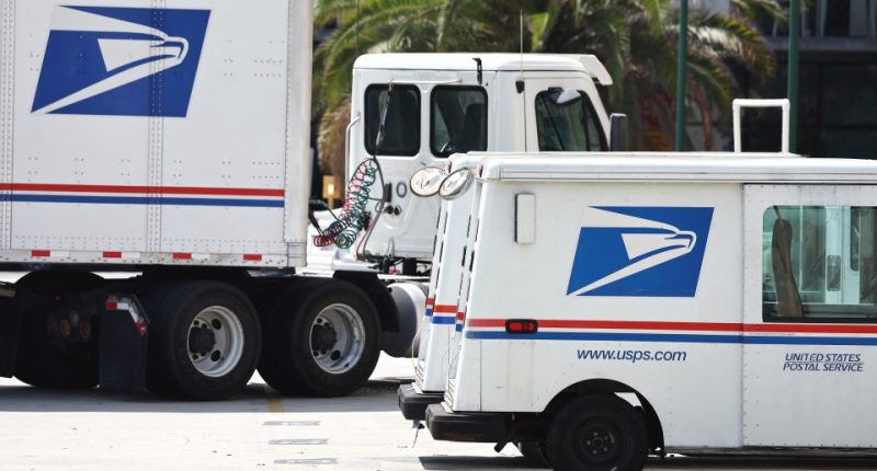 USPS trucks parked at a post office.