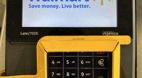 Walmart self-checkout keypad with added security belt.