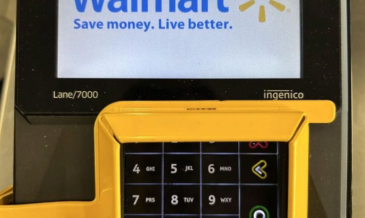 Walmart self-checkout keypad with added security belt.